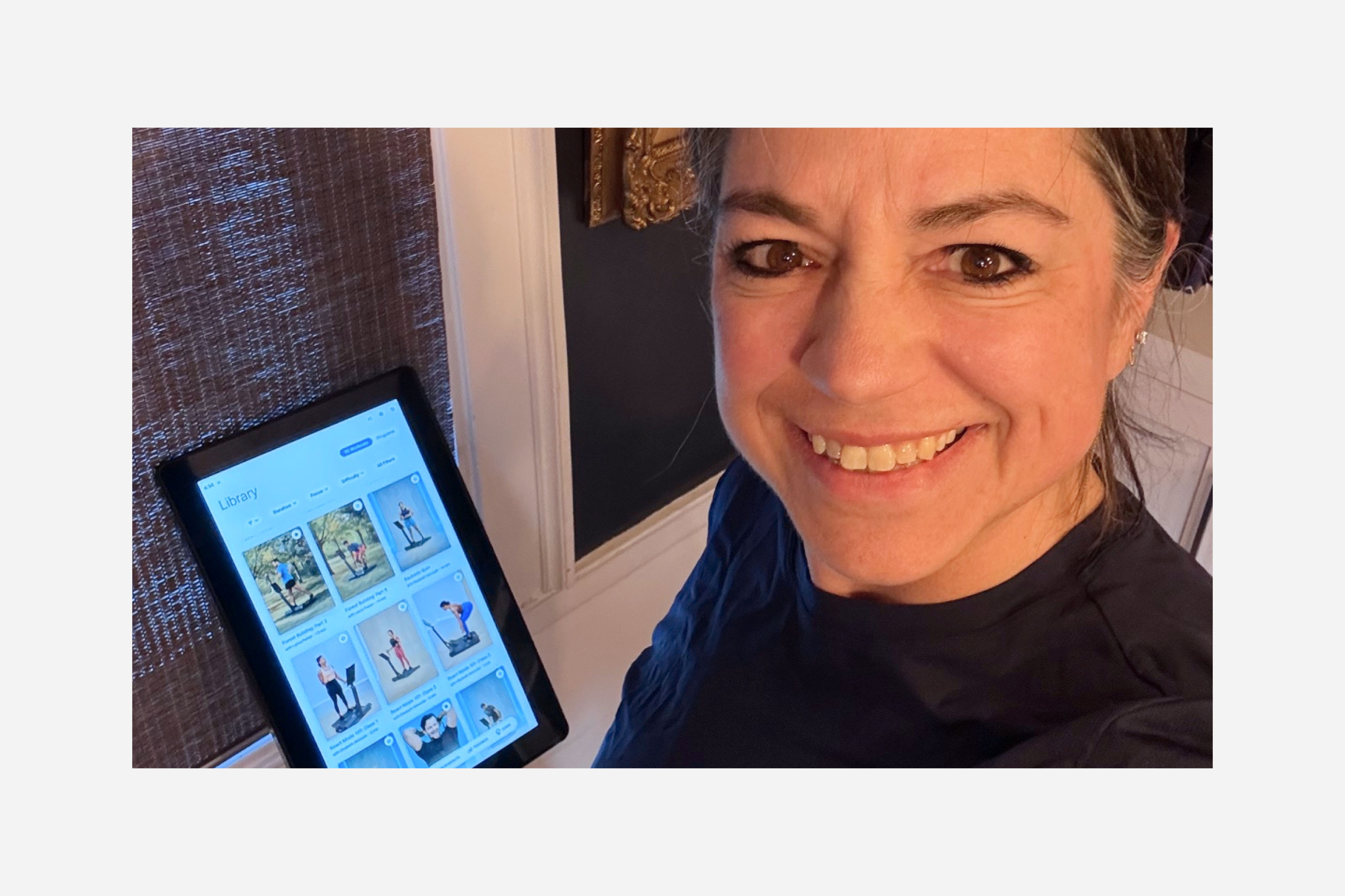 Hydrow Member Michelle Hastings stands with her LYQUID strength machine.