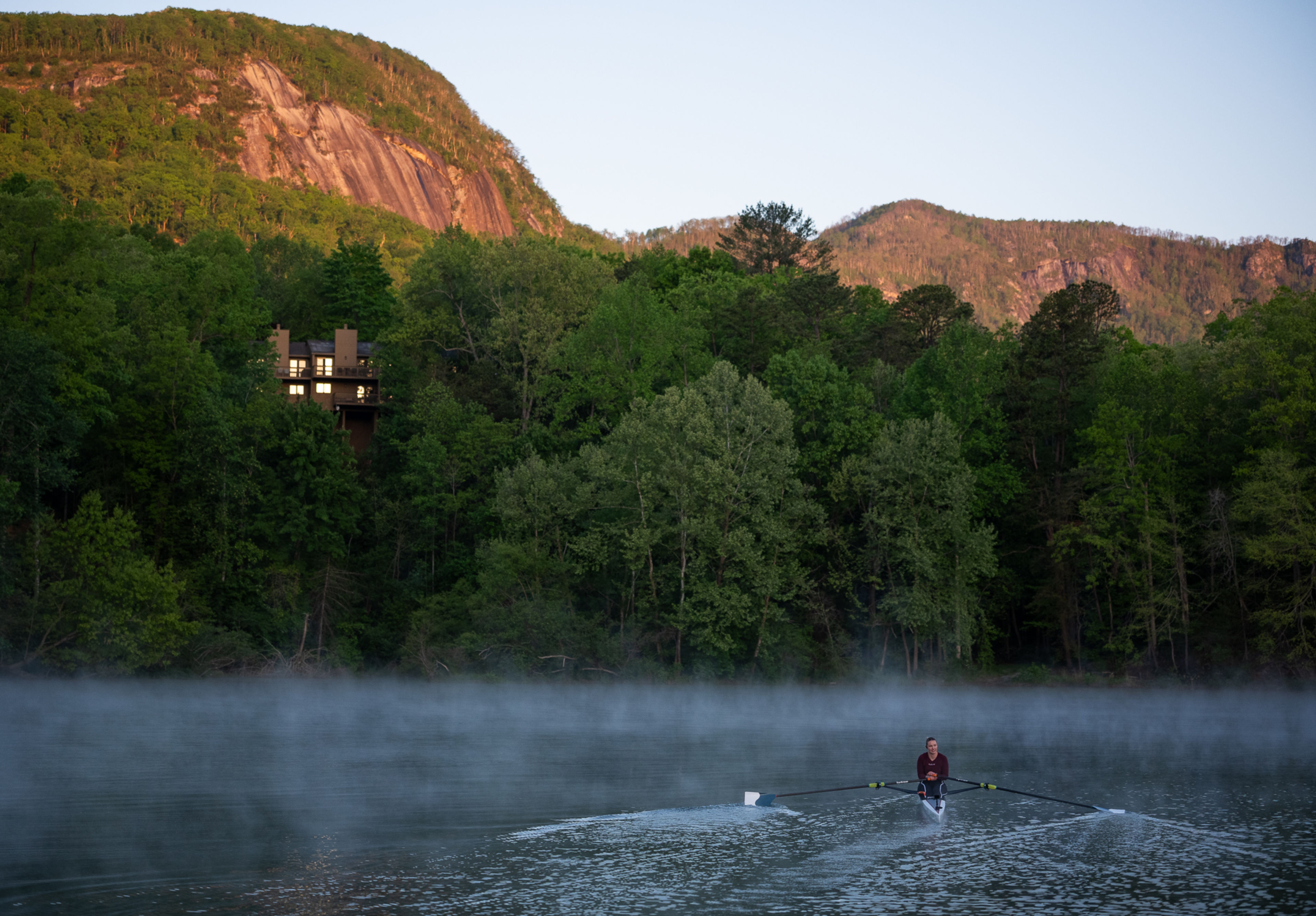 Hydrow Athlete Mac rows on Lake Lure, Hydrow's latest destination.