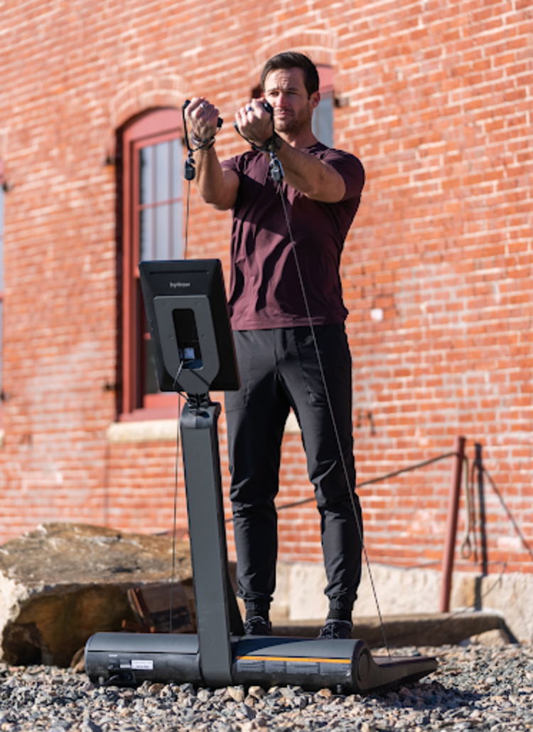 Hydrow Athlete Lance leads a beginner chest workout on the LYQUID adaptive strength platform.