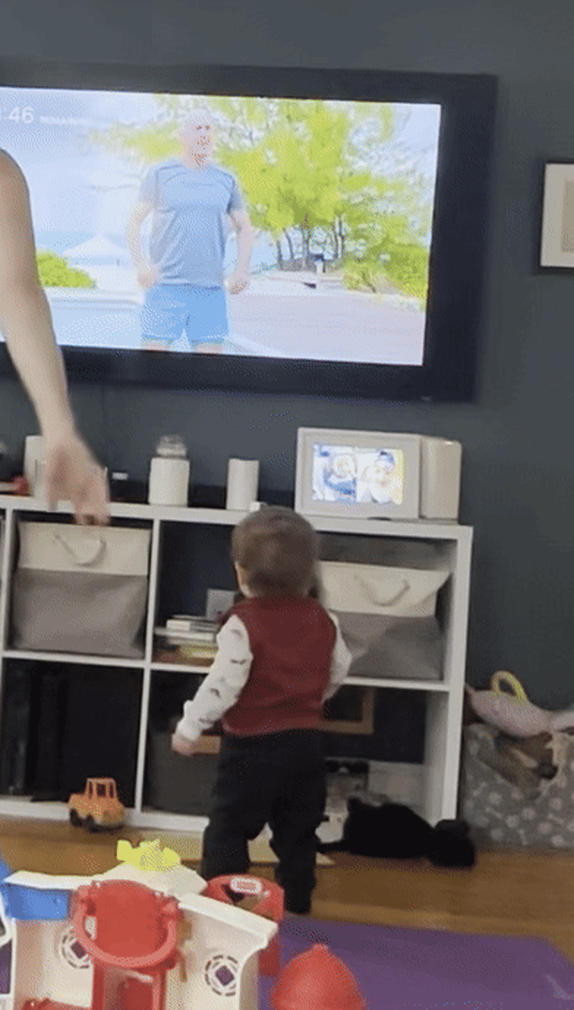 A toddler does a workout with Hydrow Athlete Pete Donohoe.
