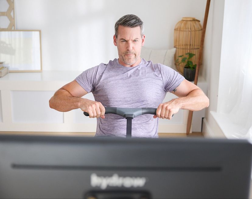 Man works out on a rowing machine to get in shape.