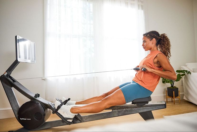 Woman does a rowing workout after asking, "can you use a rowing machine every day?"