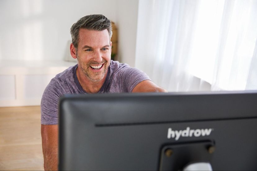 Man gets ready to work out on a rowing machine after discovering whether a rowing machine burns fat.