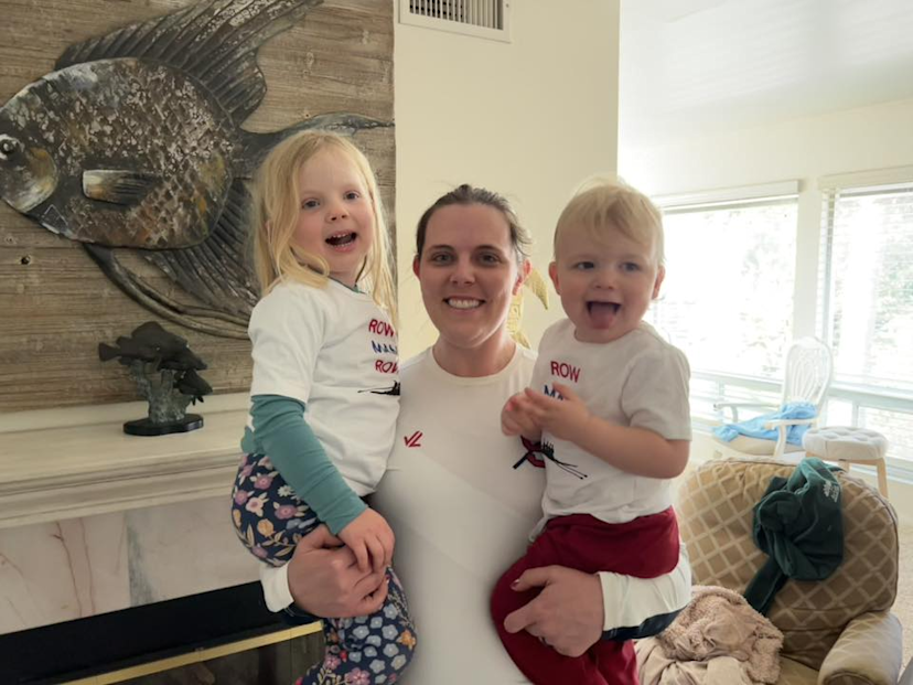 A family poses wearing rowing shirts.