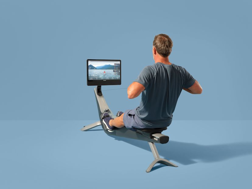 A man works out on a Hydrow Arc rowing machine.