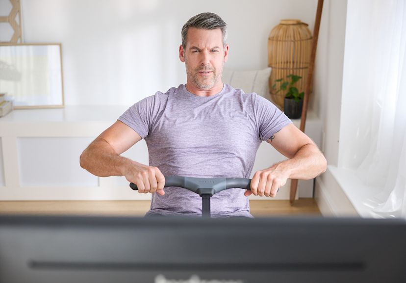 Man works out on a Hydrow rowing machine.