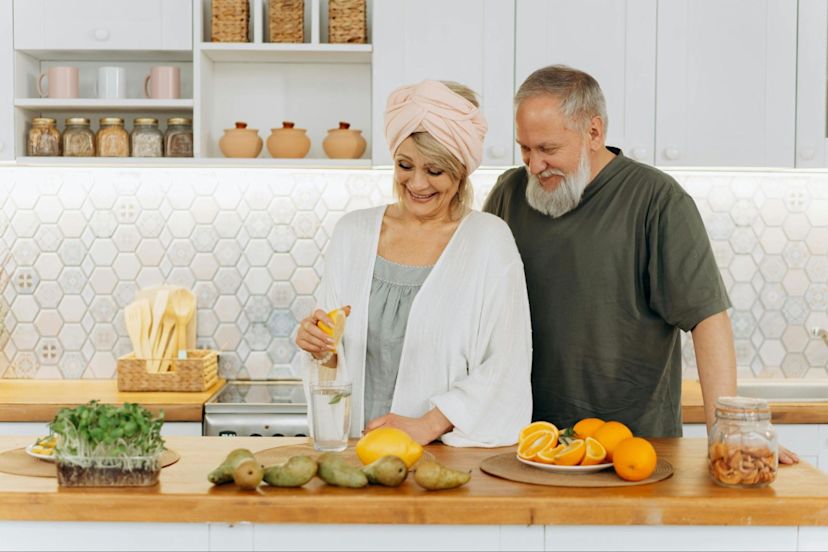 An older couple prepares food together to demonstrate proper nutrition as you age.