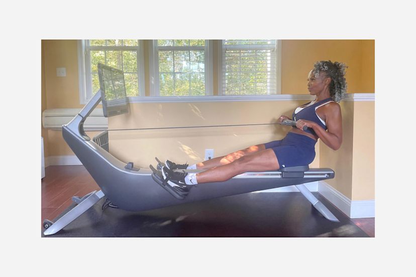 Hydrow Member Marcia Allen works out on her Hydrow rowing machine at home.