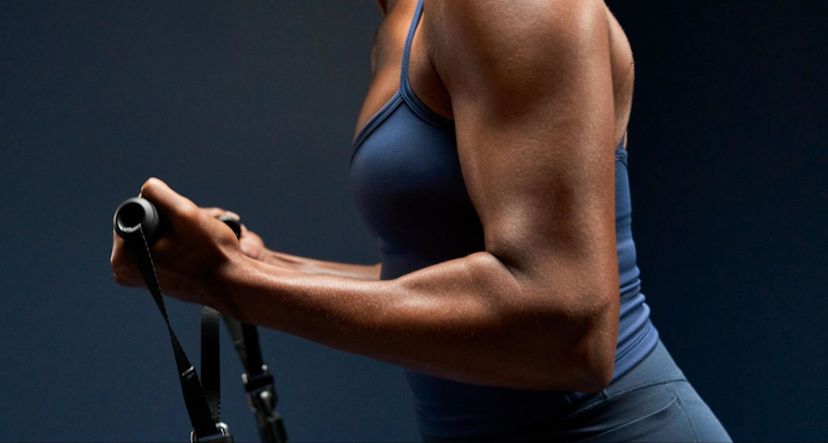 Muscular woman does an isokinetic workout.