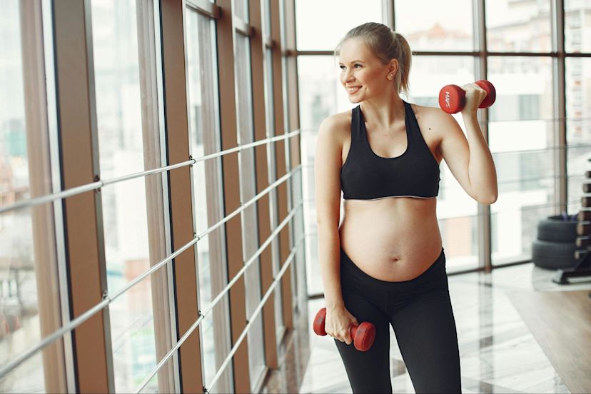 Woman does strength training workouts during pregnancy.