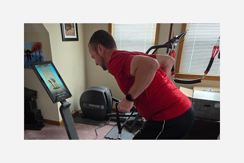 William Dobe using his LYQUID strength machine at home.
