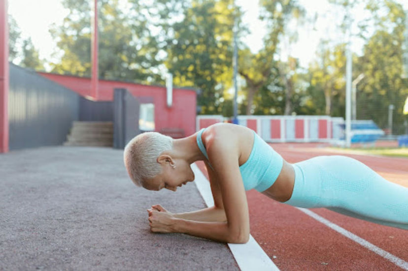 Woman does a plank, a common bodyweight workout for beginners.