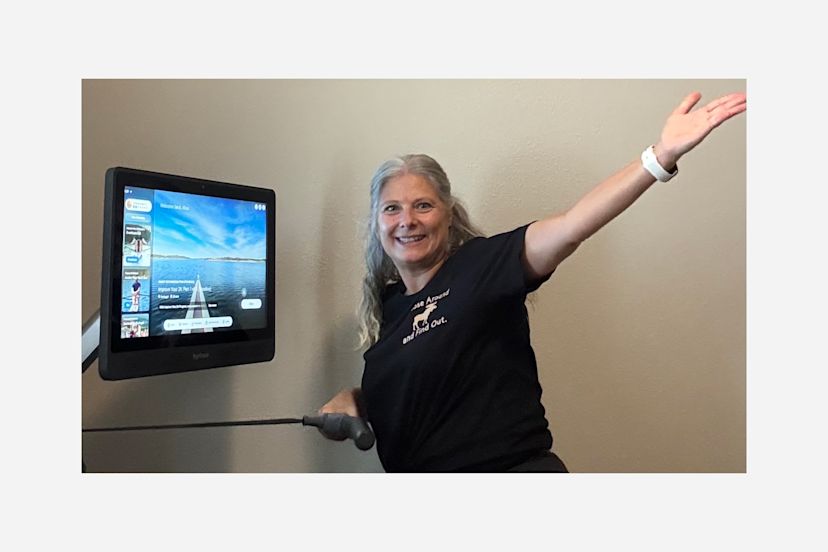 Hydrow Member Alisa poses with her Hydrow rowing machine.