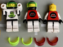 One Blacktron 2 and two M-Tron LEGO minifigures, one them missing helmet, and 4 spare helmet visors in trans-red and trans-neon green.