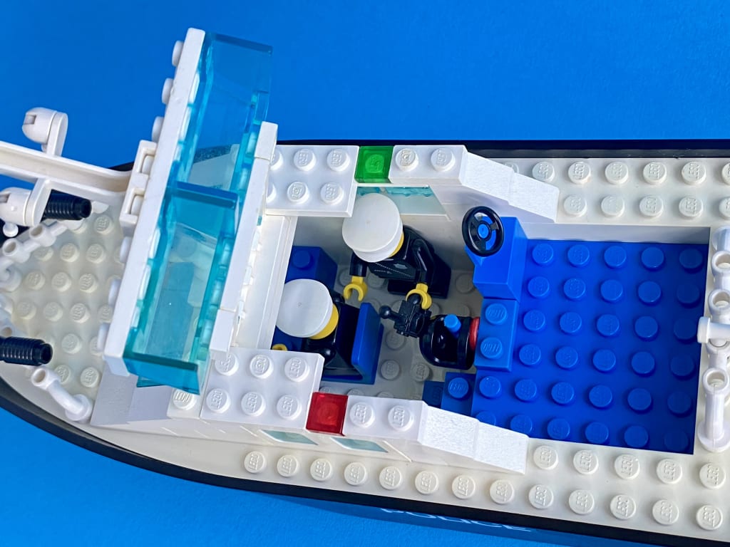 The Police Rescue Boat from above with the hatch open, showing the two police officer minifigs working below deck