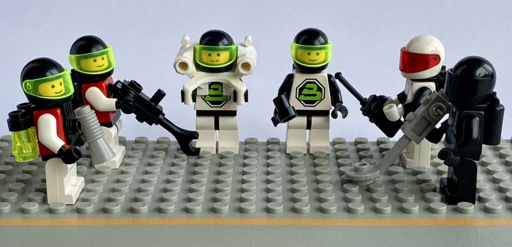 Two M-Tron, two Blacktron 2, one Space Police and one original Blacktron minifig, each with minifig accessories.