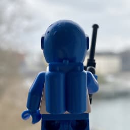 A blue Futuron LEGO minifigure with air tanks on the back