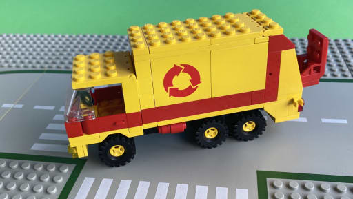 The rear loader and hopper attached to the truck body