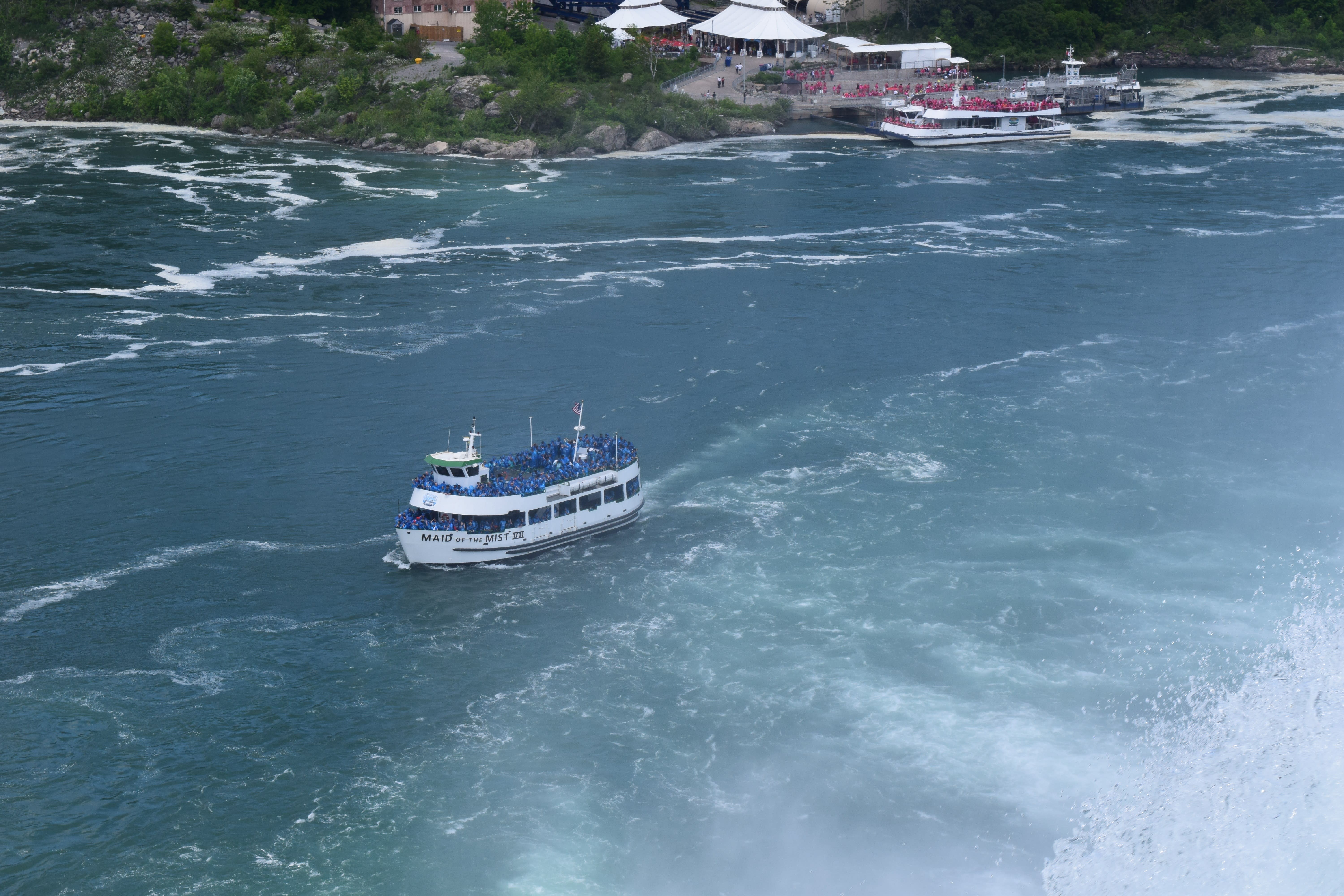 Maid of the Mist iconic blue rain-poncho boat at the base of Niagara Falls