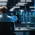 A person sits in an office at a desktop computer.