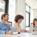 Five professionals sit in a bright conference room.