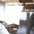 Person in an empty conference room uses a tablet computer.