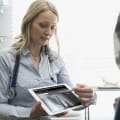 A healthcare professional shows a medical image on a tablet.