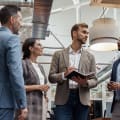 Businesspeople talking while standing in office during break