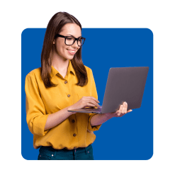 smiling woman looking at laptop