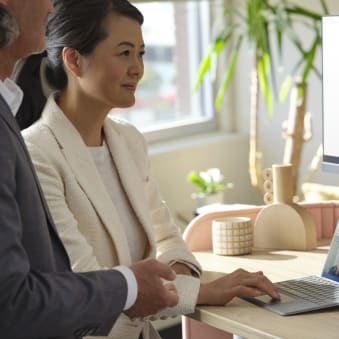 Two people review data analytics graphics on a conference call.