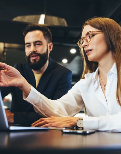 Staff from commercial services industry working in front of laptop together