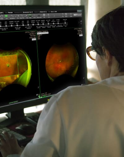 A healthcare professional uses Hyland Healthcare medical imaging products on a desktop computer.