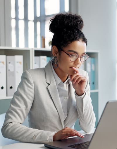 Woman working at a laptop in an office