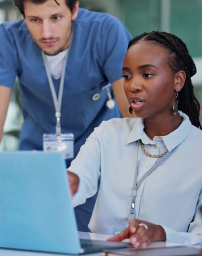 Medical personnel having a meeting and discussion with laptop