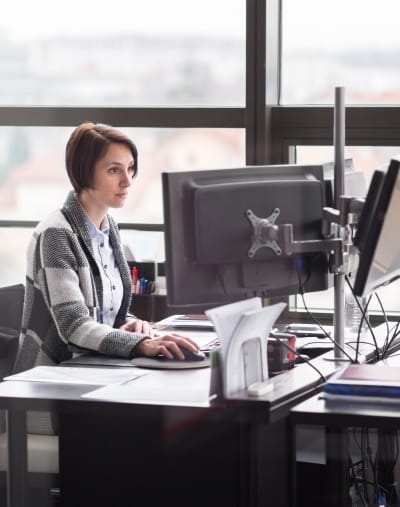 Employee sitting at a desktop computer.