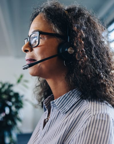 Person wearing business-casual attire and a headset with microphone.