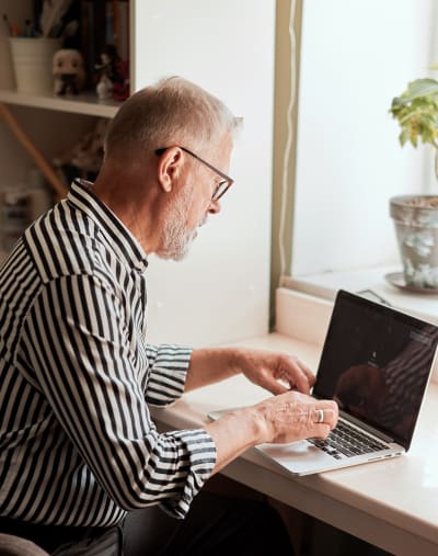 Person in a remote office works on a laptop computer.