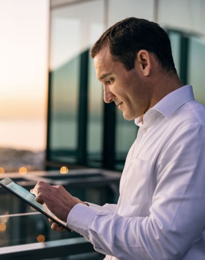 Person accesses an e-book on a tablet outdoors.