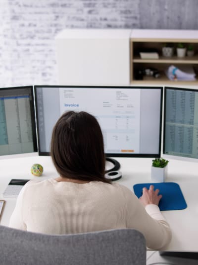 Person works at a desktop in an office.