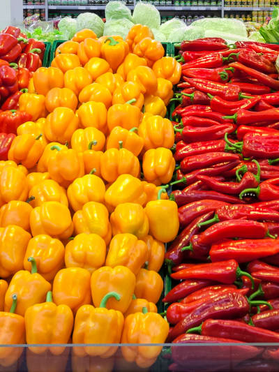 A colorful array of vegetables in a produce aisle of a grocery store