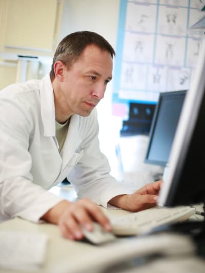 Hyland Healthcare customer uses a desktop computer in a hospital setting.