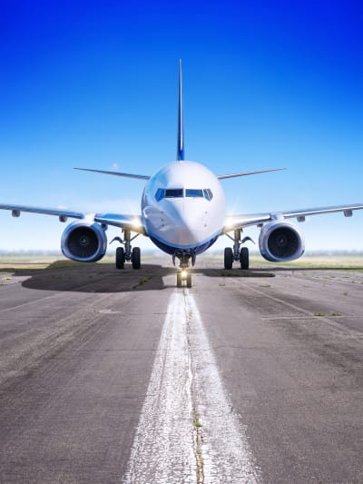 Airplane sits on the tarmac. 