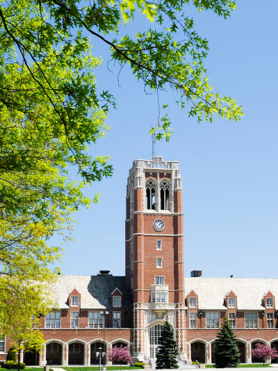 The exterior of John Carroll university, which has red brick and a tower.