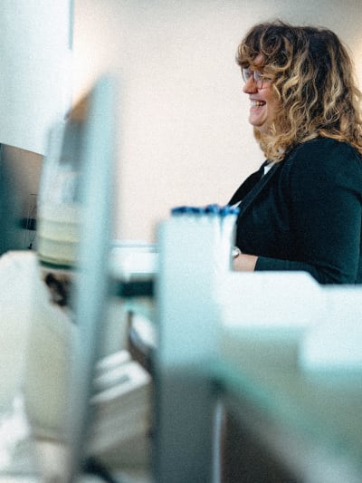 Office worker sitting in front of a desktop computer.