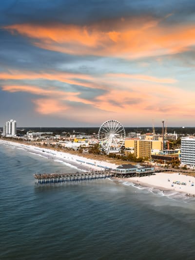 Aerial shot of Myrtle Beach showing a Ferris wheel and pier.