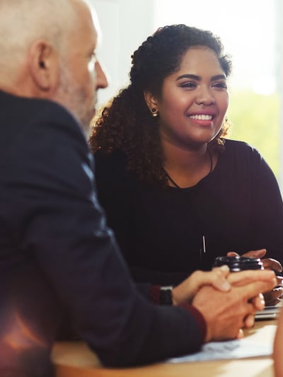 A group of technology leaders sits in a shared workspace and discuss the merits of joining the Hyland partner ecosystem.