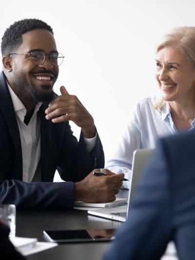 Two Hyland partners collaborate on success strategies at a conference table.