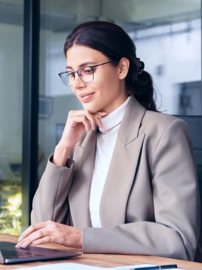 Businesswoman working on a laptop in an office setting