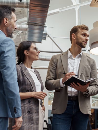 Businesspeople talking while standing in office during break