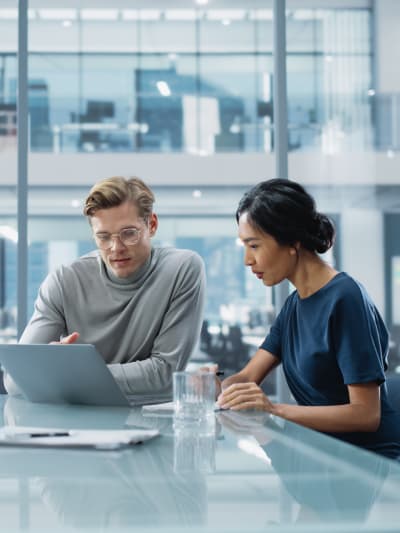Team of two coworkers having an office conference room meeting